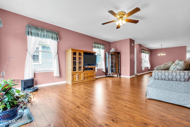 4 Beechwood Ct, Barnegat, NJ 08005 - living room with a ceiling fan, healthy amount of natural light, wood finished floors, and baseboards