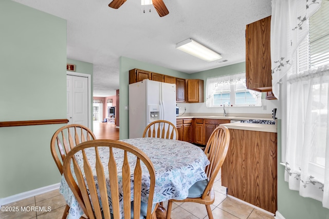 4 Beechwood Ct, Barnegat, NJ 08005 - kitchen with white refrigerator with ice dispenser, brown cabinets, light countertops, light tile patterned flooring, and a textured ceiling