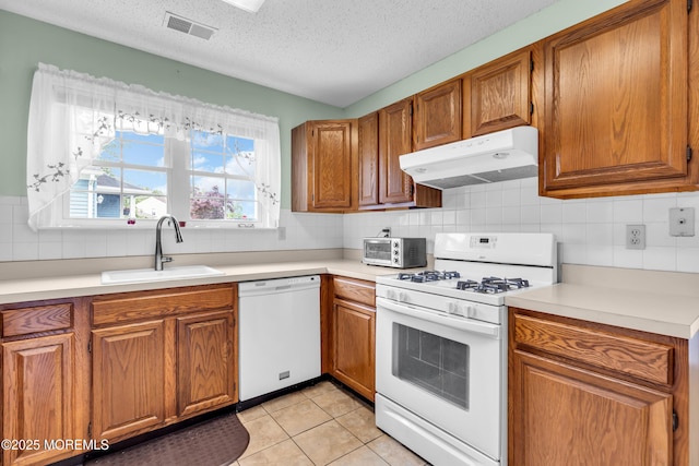 4 Beechwood Ct, Barnegat, NJ 08005 - kitchen with white appliances, under cabinet range hood, a sink, brown cabinetry, and a textured ceiling
