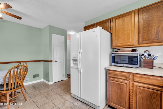 4 Beechwood Ct, Barnegat, NJ 08005 - kitchen featuring white fridge with ice dispenser, stainless steel microwave, ceiling fan, light countertops, and light tile patterned flooring