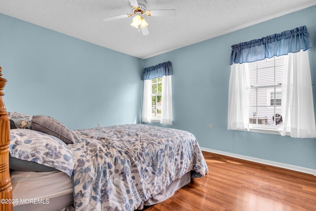 4 Beechwood Ct, Barnegat, NJ 08005 - bedroom featuring wood finished floors, a textured ceiling, baseboards, and a ceiling fan