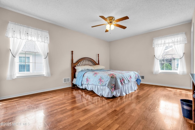 4 Beechwood Ct, Barnegat, NJ 08005 - bedroom with wood finished floors, a textured ceiling, baseboards, and ceiling fan