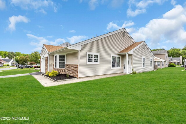 4 Beechwood Ct, Barnegat, NJ 08005 - back of property with a yard, brick siding, a garage, and roof with shingles
