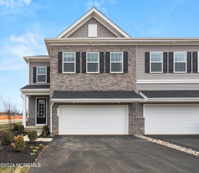 2707 Journey Ave, Marlboro, NJ 07746 - view of front of home featuring stone siding, driveway, and an attached garage