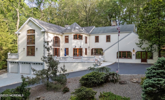 160 Pelican Rd, Middletown, NJ 07748 - french country style house featuring stucco siding, a chimney, an attached garage, and concrete driveway