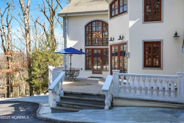 160 Pelican Rd, Middletown, NJ 07748 - view of exterior entry featuring a shingled roof, stucco siding, a deck, and french doors