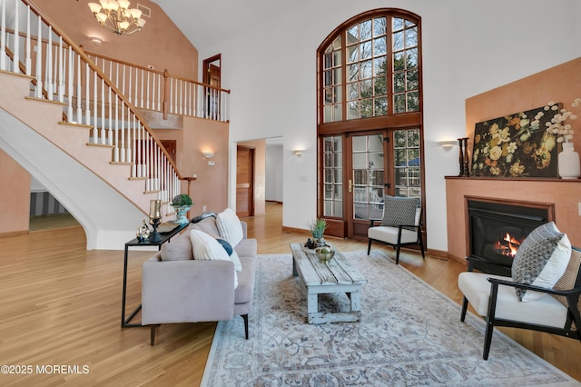 160 Pelican Rd, Middletown, NJ 07748 - living area featuring high vaulted ceiling, stairway, a glass covered fireplace, wood finished floors, and a chandelier