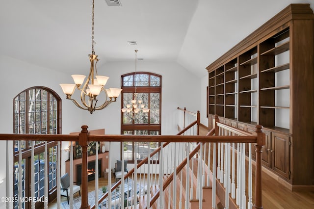 160 Pelican Rd, Middletown, NJ 07748 - corridor with a chandelier, an upstairs landing, vaulted ceiling, and wood finished floors