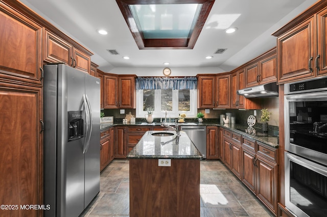 160 Pelican Rd, Middletown, NJ 07748 - kitchen featuring appliances with stainless steel finishes, an island with sink, dark stone countertops, recessed lighting, and light stone finish flooring