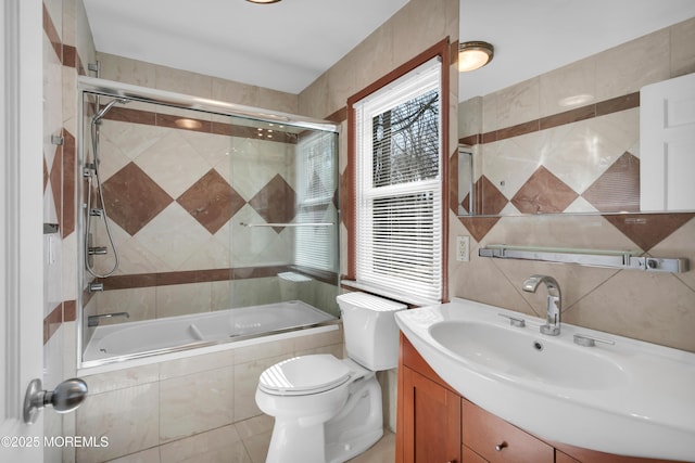 160 Pelican Rd, Middletown, NJ 07748 - bathroom featuring tiled shower / bath, toilet, vanity, tile walls, and healthy amount of natural light