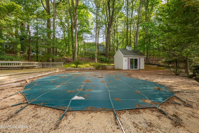 160 Pelican Rd, Middletown, NJ 07748 - view of swimming pool with an outbuilding, a covered pool, a patio area, and view of wooded area