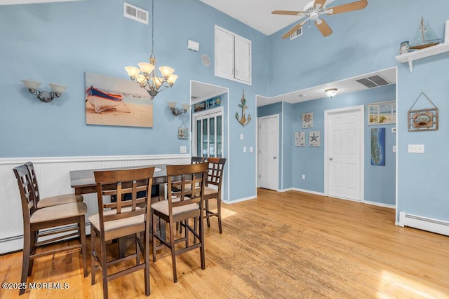 22 Franklin Ave, Hazlet, NJ 07734 - dining space with a ceiling fan, wood finished floors, a towering ceiling, a chandelier, and a baseboard heating unit