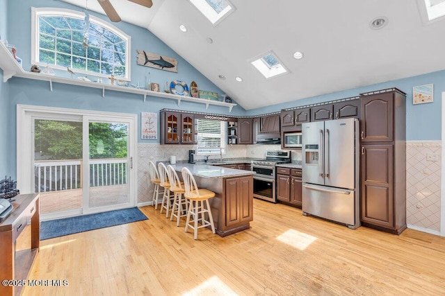 22 Franklin Ave, Hazlet, NJ 07734 - kitchen featuring stainless steel appliances, a skylight, high vaulted ceiling, light wood-style flooring, and a peninsula
