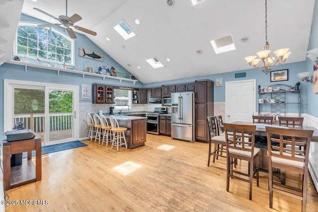 22 Franklin Ave, Hazlet, NJ 07734 - kitchen featuring appliances with stainless steel finishes, high vaulted ceiling, a skylight, a breakfast bar, and a chandelier
