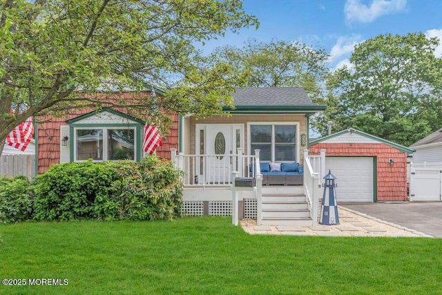 22 Franklin Ave, Hazlet, NJ 07734 - view of front facade with an outdoor structure, asphalt driveway, and a garage