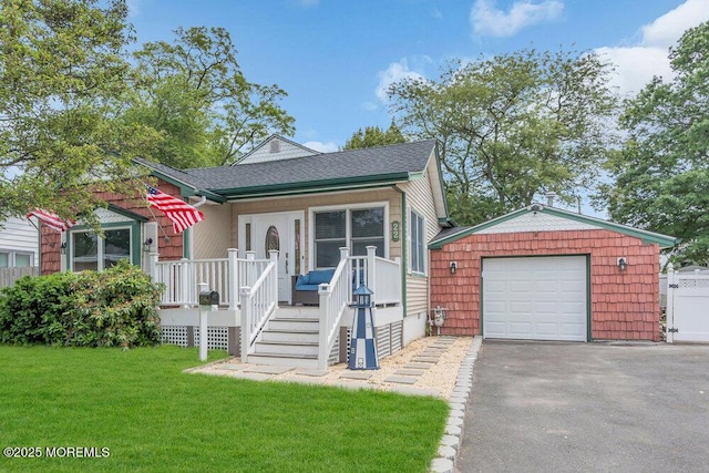 22 Franklin Ave, Hazlet, NJ 07734 - view of front facade with asphalt driveway, a detached garage, a front yard, a shingled roof, and a wooden deck