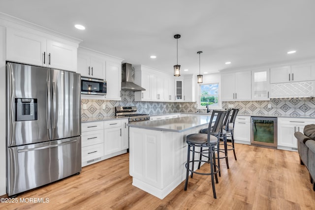 303 Forman Ave, Point Pleasant Beach, NJ 08742 - kitchen with stainless steel appliances, beverage cooler, wall chimney range hood, white cabinets, and recessed lighting
