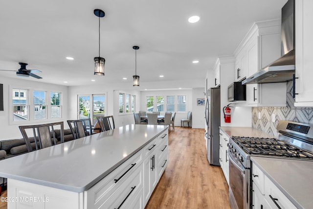303 Forman Ave, Point Pleasant Beach, NJ 08742 - kitchen featuring appliances with stainless steel finishes, wall chimney exhaust hood, open floor plan, light wood-style flooring, and recessed lighting