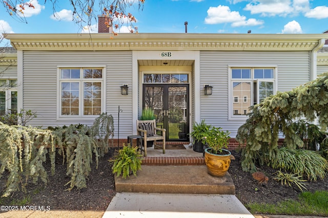 68 Winthrop Rd Unit 68B, Monroe, NJ 08831 - view of exterior entry with a chimney and covered porch