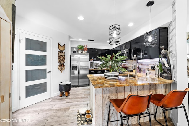 68 Winthrop Rd Unit 68B, Monroe, NJ 08831 - kitchen with appliances with stainless steel finishes, dark cabinets, light wood-style flooring, a peninsula, and recessed lighting