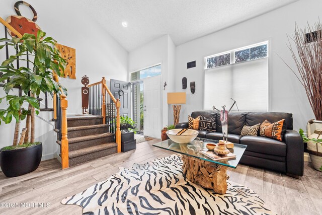 68 Winthrop Rd Unit 68B, Monroe, NJ 08831 - living area featuring high vaulted ceiling, stairs, wood finished floors, recessed lighting, and a textured ceiling