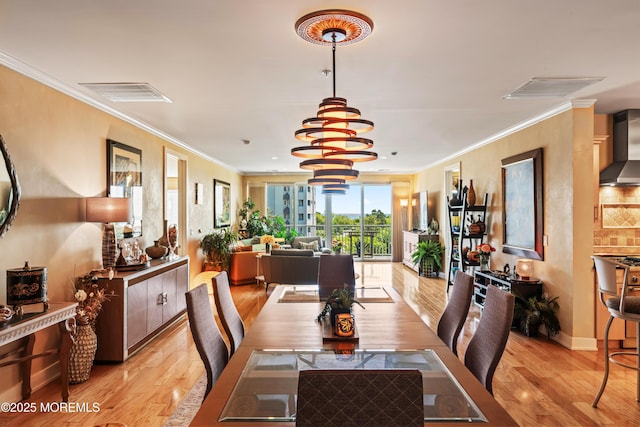 432 Ocean Blvd Unit 208, Long Branch, NJ 07740 - dining space featuring light wood-type flooring, crown molding, a chandelier, and baseboards