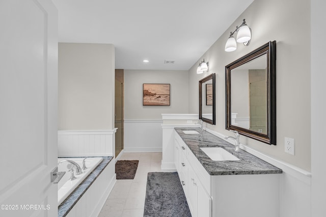 804 Linden Rd, Toms River, NJ 08753 - full bath with double vanity, a garden tub, wainscoting, and a shower