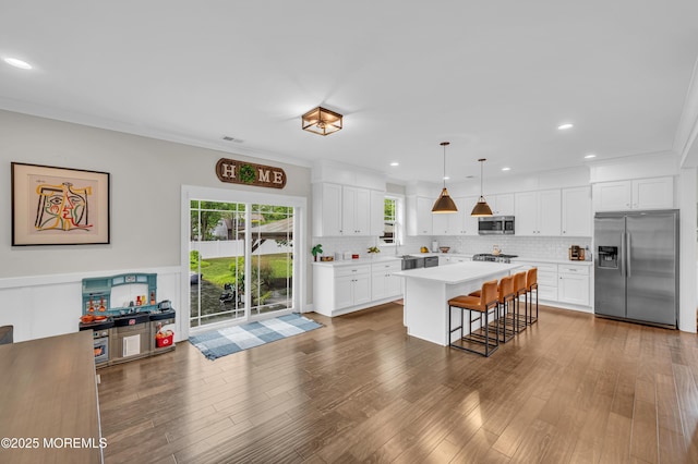 804 Linden Rd, Toms River, NJ 08753 - kitchen with stainless steel appliances, light countertops, white cabinetry, a kitchen bar, and recessed lighting