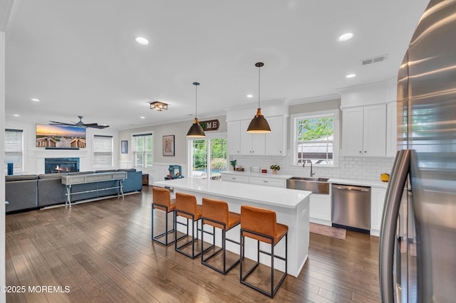 804 Linden Rd, Toms River, NJ 08753 - kitchen with stainless steel appliances, a sink, a kitchen breakfast bar, a ceiling fan, and dark wood finished floors