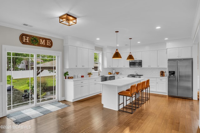 804 Linden Rd, Toms River, NJ 08753 - kitchen featuring stainless steel appliances, light countertops, decorative backsplash, white cabinetry, and crown molding