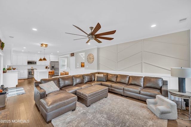 804 Linden Rd, Toms River, NJ 08753 - living area with ceiling fan, a decorative wall, crown molding, wood finished floors, and recessed lighting