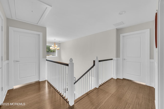 804 Linden Rd, Toms River, NJ 08753 - corridor with an upstairs landing, wood finished floors, a chandelier, and a wainscoted wall