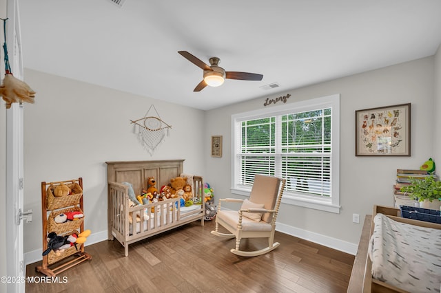 804 Linden Rd, Toms River, NJ 08753 - bedroom with wood finished floors, a crib, baseboards, and a ceiling fan