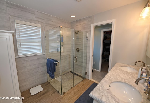 15 Tamarack St, Howell, NJ 07731 - full bathroom featuring a stall shower, wood finished floors, a spacious closet, and double vanity