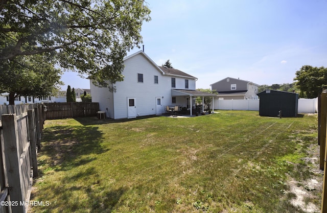 15 Tamarack St, Howell, NJ 07731 - back of house with a fenced backyard, a patio, and a storage unit