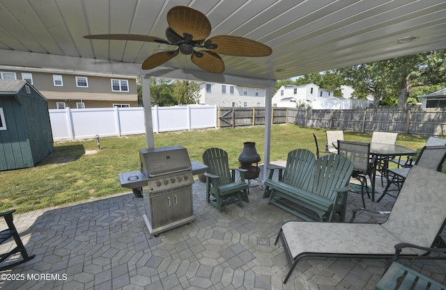 15 Tamarack St, Howell, NJ 07731 - fenced backyard with a patio, a storage shed, outdoor dining space, a grill, and ceiling fan