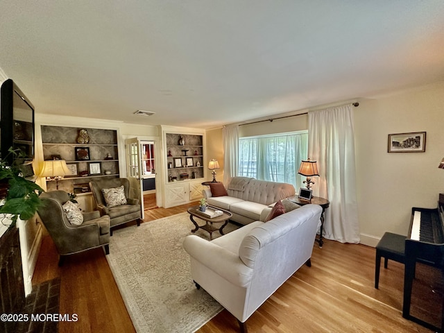 8 Spruce St, Toms River, NJ 08753 - living room with wood finished floors, built in shelves, and baseboards