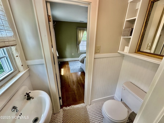 8 Spruce St, Toms River, NJ 08753 - half bathroom featuring toilet, a wainscoted wall, and ensuite bathroom