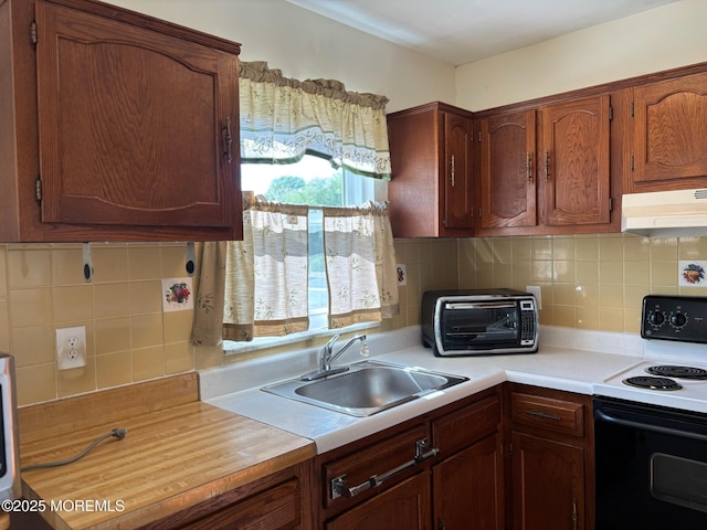 10 Monmouth Ln Unit B, Whiting, NJ 08759 - kitchen with electric stove, under cabinet range hood, a sink, light countertops, and decorative backsplash