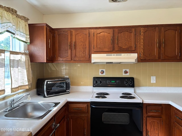 10 Monmouth Ln Unit B, Whiting, NJ 08759 - kitchen featuring electric stove, under cabinet range hood, a sink, light countertops, and tasteful backsplash