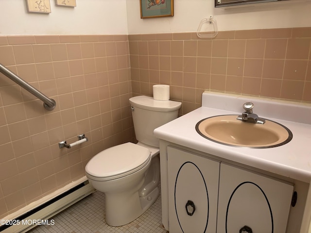 10 Monmouth Ln Unit B, Whiting, NJ 08759 - half bath featuring baseboard heating, vanity, toilet, tile walls, and tile patterned flooring