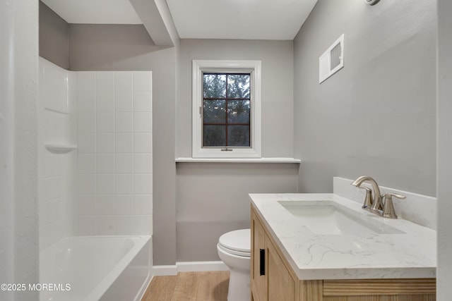 26 Nevada Dr, Hazlet, NJ 07730 - full bathroom featuring vanity, toilet, wood finished floors, baseboards, and shower / washtub combination