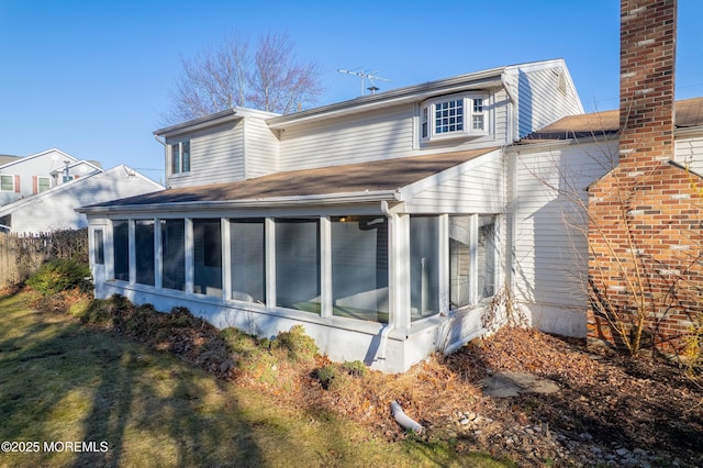 26 Nevada Dr, Hazlet, NJ 07730 - rear view of property with a sunroom, a shingled roof, and a chimney