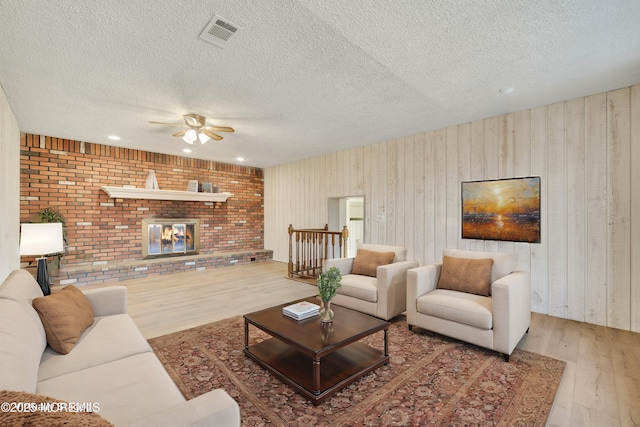 26 Nevada Dr, Hazlet, NJ 07730 - living area with wood finished floors, a ceiling fan, a textured ceiling, recessed lighting, and wood walls