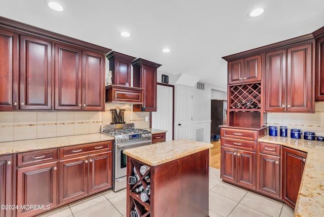137 Church St, Fair Haven, NJ 07704 - kitchen with stainless steel range with gas stovetop, dark brown cabinets, decorative backsplash, and recessed lighting