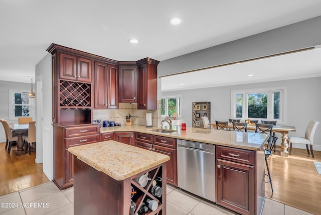 137 Church St, Fair Haven, NJ 07704 - kitchen featuring stainless steel dishwasher, reddish brown cabinets, a peninsula, light stone countertops, and recessed lighting