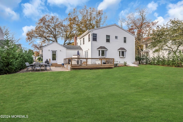 137 Church St, Fair Haven, NJ 07704 - back of property with a wooden deck, a lawn, and a patio area