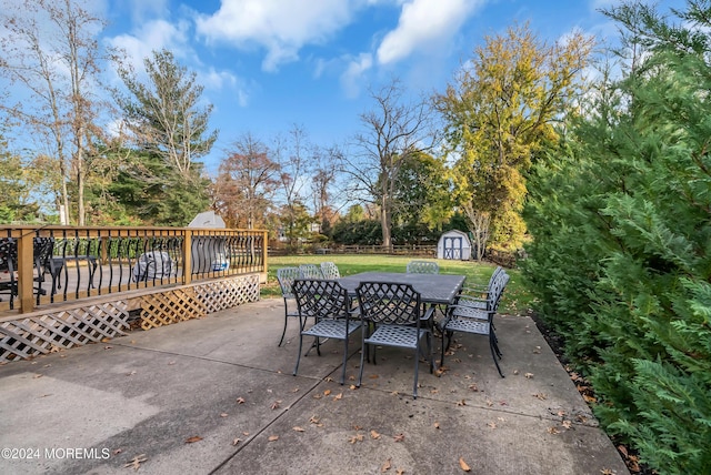 137 Church St, Fair Haven, NJ 07704 - view of patio / terrace with a storage shed, outdoor dining area, a deck, and view of wooded area