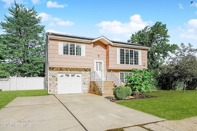 18 Croman Ct, Hazlet, NJ 07730 - raised ranch featuring roof mounted solar panels, concrete driveway, stone siding, and a garage