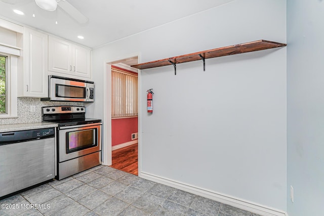 18 Croman Ct, Hazlet, NJ 07730 - kitchen featuring stainless steel appliances, open shelves, white cabinets, a ceiling fan, and light tile patterned floors